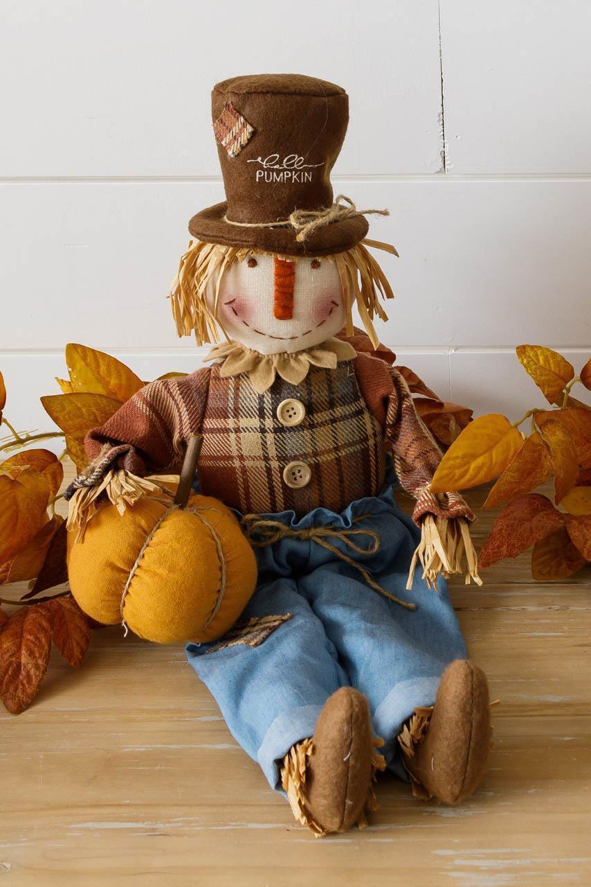 Scarecrow Holding Pumpkin